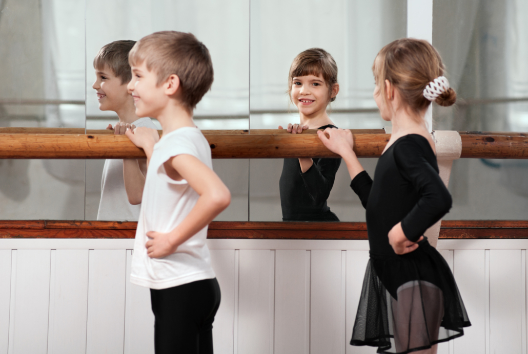 Funny,Children,Standing,At,Ballet,Barre